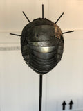 Paolo Fiorellini, maschera "Corona", Ecce Homo, alluminio e tela di iuta, 30x180
